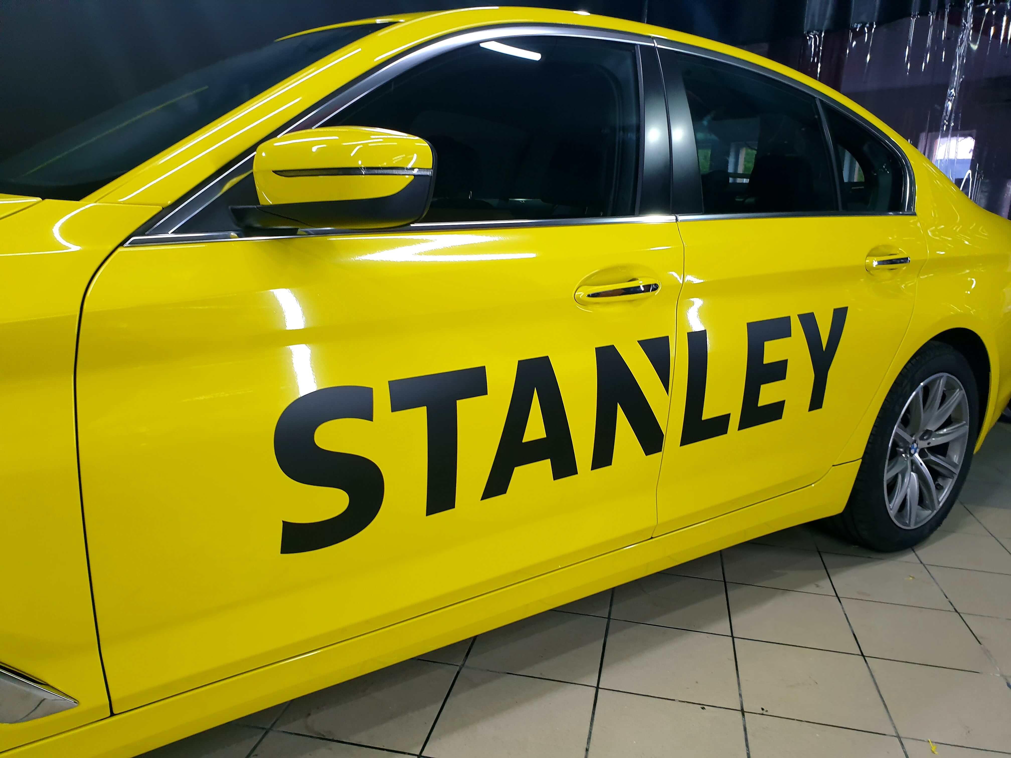 Yellow car with large-format commercial graphics applied by XWrap